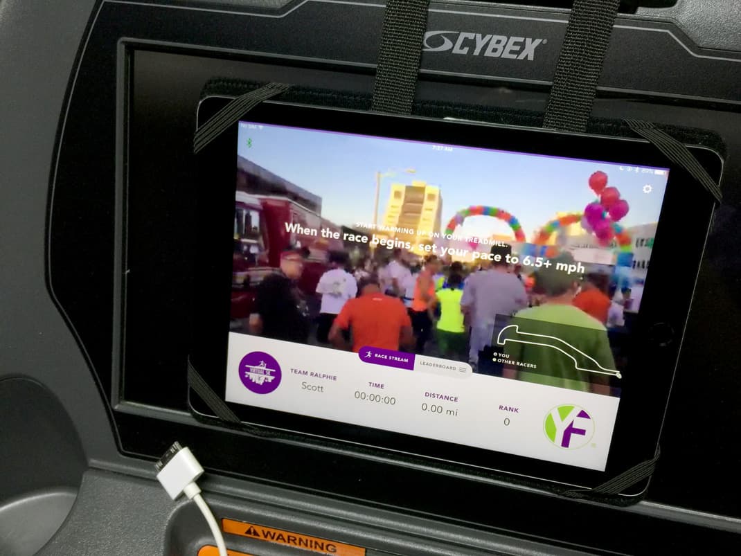 Close-up of the Virtual 5K tablet mid-race, showing the pace-synced livestream and an instruction to set treadmill speed to 6.5+ mph